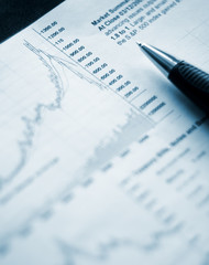 Closeup of a pen near the graph, selective focus