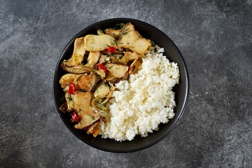 Fried oyster mushrooms with chili pepper, garlic and soy sauce with boiled rice. Healthy food.