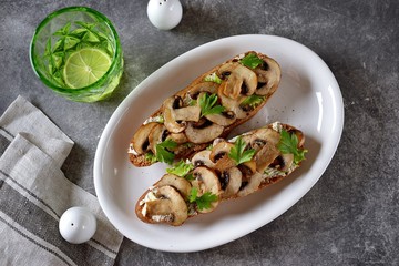 Sandwiches of rye bread with soft cheese and fried mushrooms. Healthy vegetarian food.