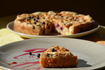homemade charlotte pie with apples and berries  piece of cake on a plate blueberries and berry syrup