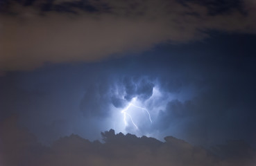 A Lightning at cloudy dark sky scene.