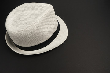 Белая шляпа на черном фоне