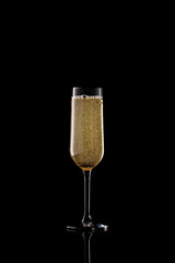full champagne glass on black background