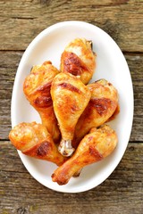 Chicken drumsticks baked in marinade with tomato sauce, soy sauce and olive oil.