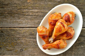 Chicken drumsticks baked in marinade with tomato sauce, soy sauce and olive oil.