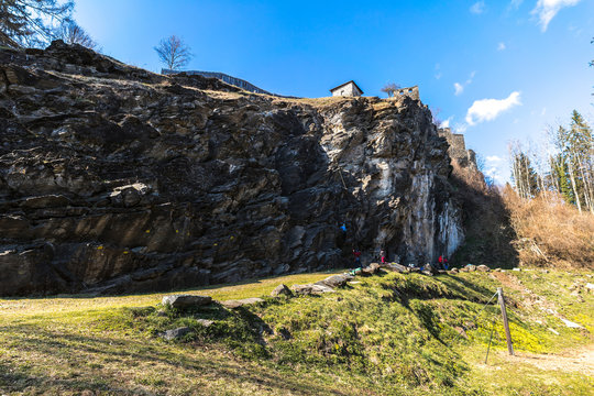 Climbing in Liebenfels, Austria. Climbing area or crag under the castle of Burgruine Liebenfels. Climbers on a rock. Sport climbing on a sunny day.