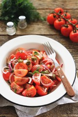 Cherry tomato salad with red onions, capers and dill, with olive oil, soy sauce and wine vinegar dressing. Healthy food.