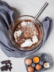 Ingredients for cake made from chocolate and chestnut puree in bowl ready for mixing up. Overhead shot.