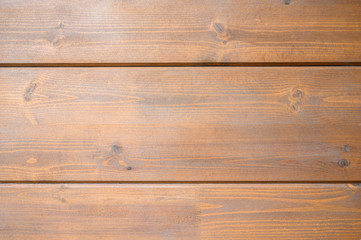 Wall texture of new wooden house painted with natural brown oil color.