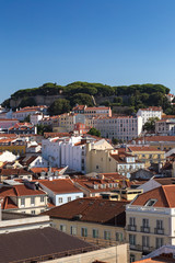 Fototapeta na wymiar View of Sao Jorge Castle (Saint George Castle, Castelo de Sao Jorge) and old buildings at the historical Alfama district in downtown Lisbon, Portugal, on a sunny day in the summer. Copy space.