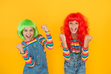 Sisters having fun. Semi permanent color cream. Colored clip in hair extensions. Change color. Kids girls with vibrant hairstyle. Pigment dye hair. Freedom for expression. Fantasy hair trend