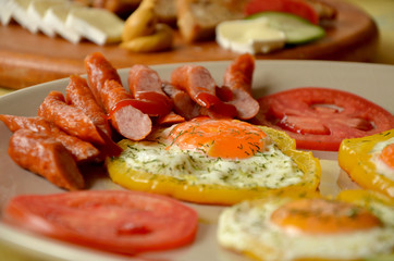 breakfast fried eggs with vegetables and sausages and   croutons 