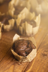 Tasty chocolate muffins on the wooden table