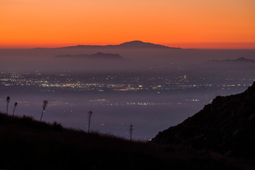 Foggy dawn view across the San Fernando Valley towards Griffith Park and Santiago Peak in Los Angeles California.  