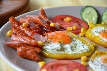 breakfast fried eggs with vegetables and sausages and   croutons 