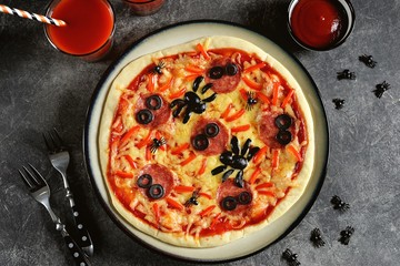 Cute pizza with olives and sausage spider for Halloween party. Children's food. 