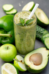 Green smoothie of apple, cucumber, avocado and pepper in a glass
