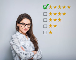 The best rating, evaluation. Business confident happy woman voting to five yellow star to increase...