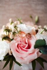 Pale pink bridal bouquet with delicate pink flowers with rings.