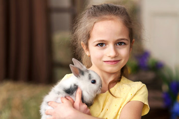 Cute little girl with a bunny rabbit