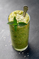 Vegetable green smoothie on a dark background
