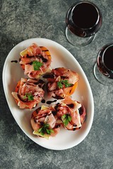 Grilled peaches with soft brie cheese, Parma ham and balsamic cream.