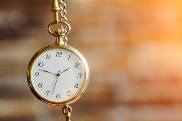 vintage clock hanging on an old brick wall