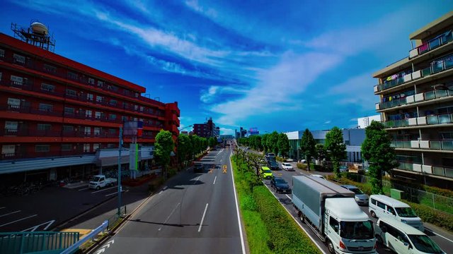 A timelapse of downtown street at Kanpachi avenue in Tokyo daytime wide shot tilt