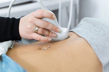 The doctor is preparing to conduct ultrasound research. smears the gel ultrasonic sensor