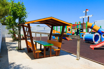 Fototapeta na wymiar Children's wooden playground recreation area at public park