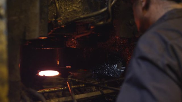 Worker at an industrial forge