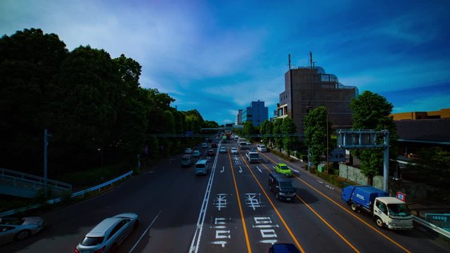 A timelapse of downtown street at Kanpachi avenue in Tokyo daytime wide shot tilt
