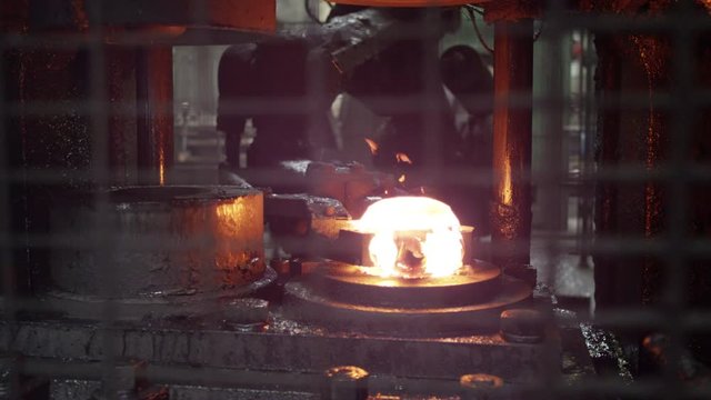 Industrial forge automated machinery, slow motion
