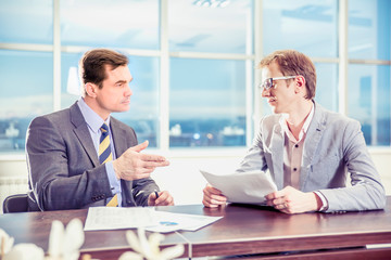 two businesspeople interacting at meeting	