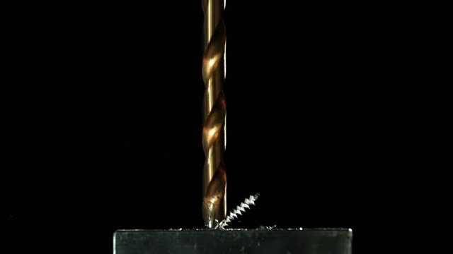 Slow motion close up, drill bit drills metal