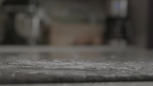 Close up, powdered donut rolling in slow motion