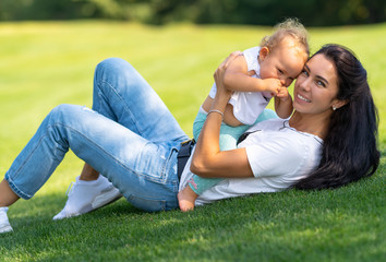 Happy young mother playing with her baby child