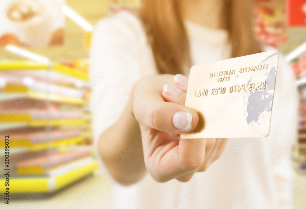 Wall mural Woman with  credit card holding by hand.