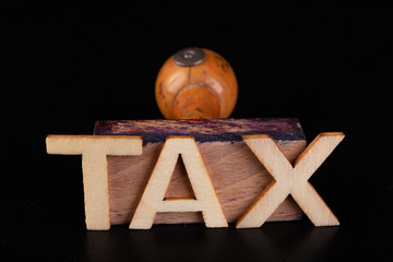 Inscription tax old rubber stamp. Office accessories on a dark table.
