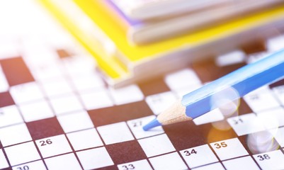 Crossword Puzzle and Pencil on background