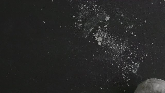 Overhead close up, powdered donuts falling