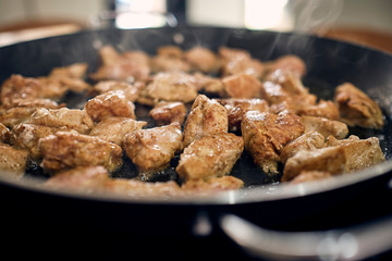 chicken in a pan being sauteed with teriyaki sauce