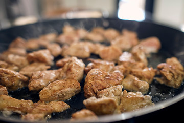 chicken in a pan being sauteed with teriyaki sauce