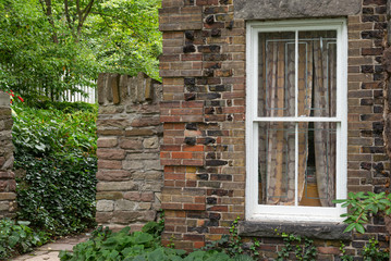 View at white window in brown blocks wall