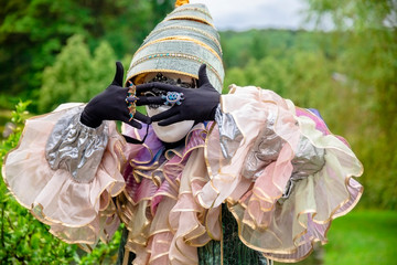 Mysterious man in masquerade mask with hands covering face