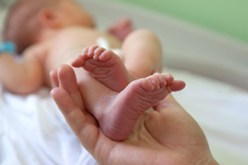 Infant heels in mother's  hands