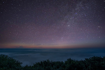 Obraz na płótnie Canvas Stars in the predawn sky and fog