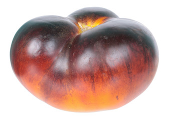 Fresh ripe black tomato isolated on white background