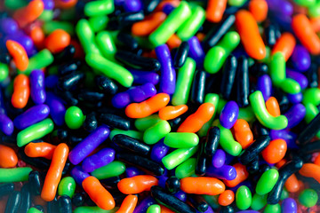 background of colorful candy halloween black purple green and orange candy