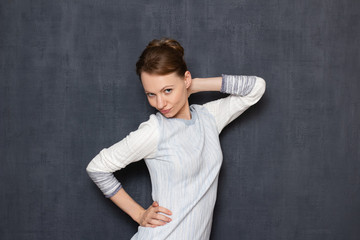 Portrait of comic flirtatious girl imitating sexy photo pose